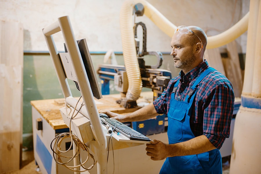 Joinery manufacturer using detailed drafting documentation in a workshop